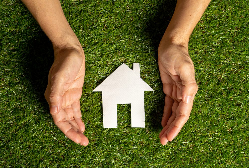 Relieved client holding keys to a new rental home